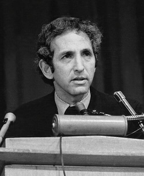 Man speaking at podium with microphones